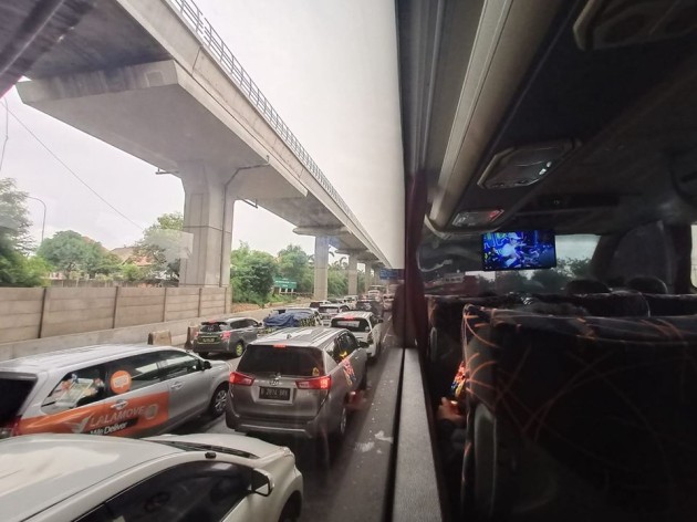 Foto - Tol Jakarta-Cikampek Kebanjiran, Bus AKAP Terjebak Macet di Jalan Raya Kalimalang